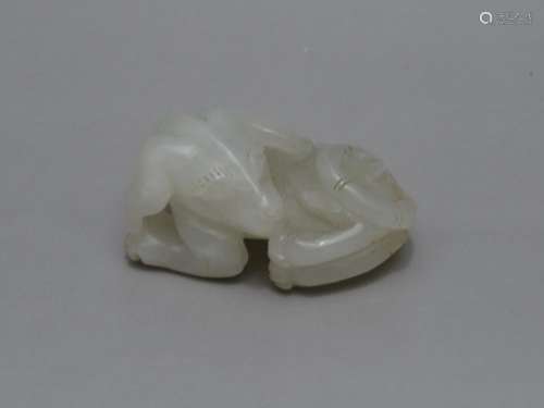 A WHITE JADE FIGURE OF DOG