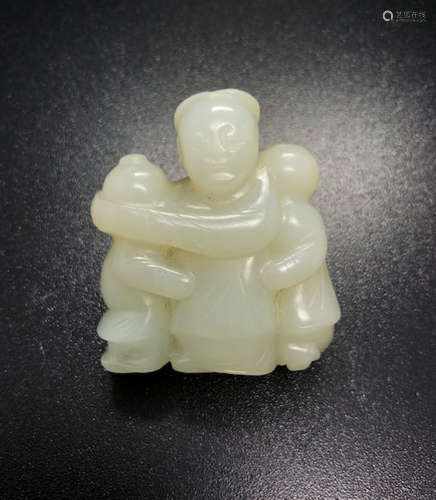 A WHITE AND RUSSET JADE FIGURAL CARVING