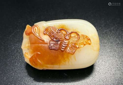 A WHITE AND RUSSET JADE 'MELON AND BUTTERFLY' CARVING