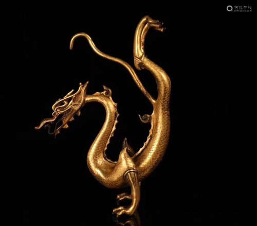 A GILT BRONZE MOLDED DRAGON SHAPED PENDANT