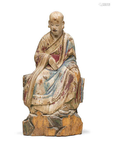 Ming dynasty A POLYCHROMED WOOD FIGURE OF A LUOHAN