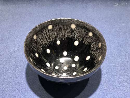 A Black-Glazed Tea Cup With White Dots