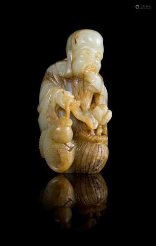 A Celadon and Brown Jade Figure of the Immortal of