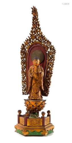 * A Japanese Gilt and Red Lacquered Wood Figure of