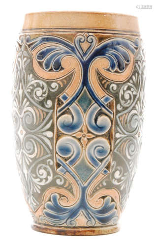 A late 19th Century Doulton Lambeth beaker decorated in the round with a repeat foliate pattern with carved and tubelined detailing