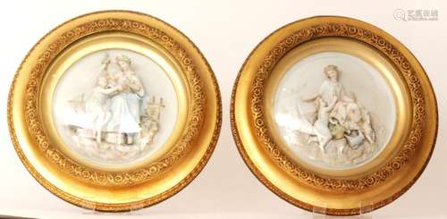 A pair of early 20th Century continental circular bisque plaques