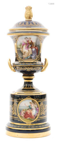 A late 19th to early 20th Century continental pedestal vase and cover decorated in the manner of Royal Vienna