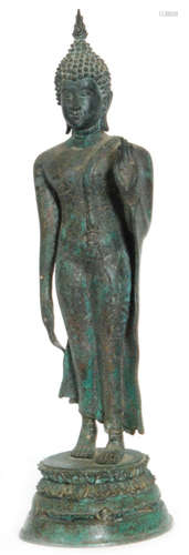 A Thai verdigris patinated bronze Buddha in the walking position with abhaya mudra gesture