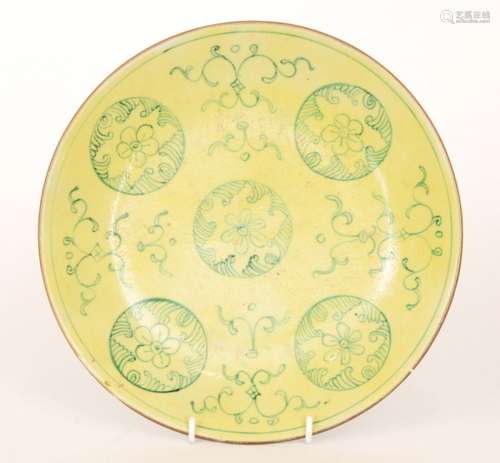 A 19th Century Chinese plate of circular dish form decorated with green mon roundels over a yellow glazed ground