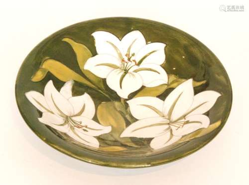 A Moorcroft bowl decorated in the Bermuda Lily pattern with white tubelined flowers against a green ground