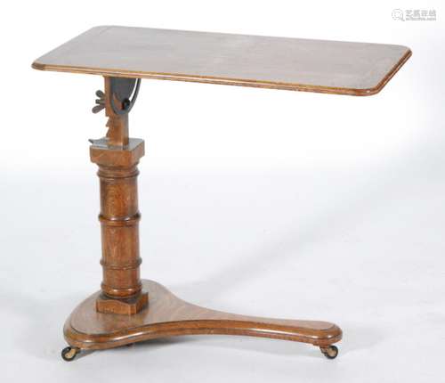 A Victorian oak invalids table on turned pedestal support