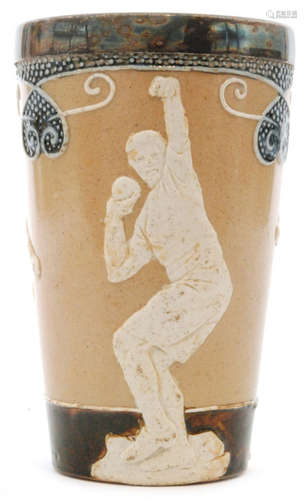 An early 20th Century Doulton Lambeth beaker decorated with three relief moulded sportsmen - one doing the long jump