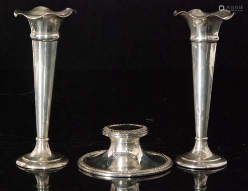 A pair of hallmarked silver trumpet vases of plain form