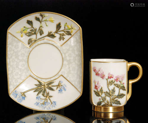 A late 19th Century Royal Worcester Aesthetic coffee can and saucer of squared form decorated with raised sprays of flowers flanked by a grey prunus blossom print