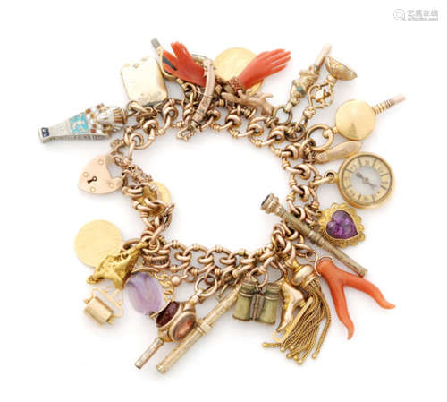 A hallmarked 9ct charm bracelet with multiple charms to include coral amulets