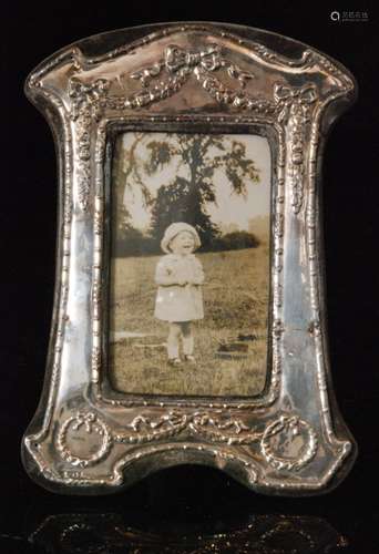 An Edwardian style hallmarked silver rectangular easel photograph frame with embossed ribbon and swag decoration