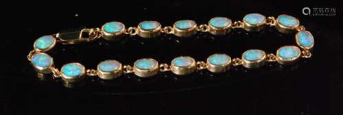 A modern 9ct hallmarked opal bracelet comprising of sixteen oval collar set stones terminating in lobster clasp