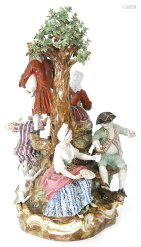 A large early 19th Century Marcolini Meissen figural group after the original by M.V Acier and J.C Schonheit modelled as a hurdy gurdy player and a bagpiper upon a hillock with four figures dancing