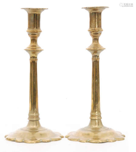 A pair of early 18th Century cast brass candlesticks on foliate bases