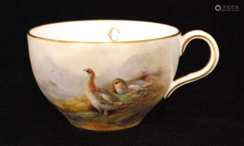 A Royal Worcester teacup panel decorated by James Stinton with two hand painted grouse in a Highland landscape