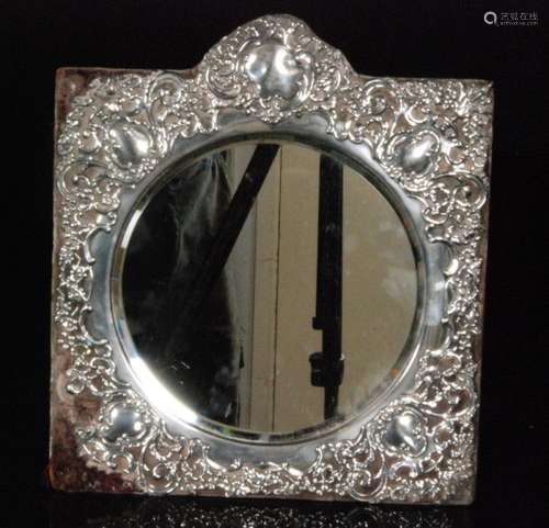 A silver easel mirror