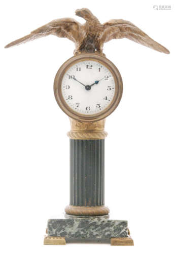 A 19th Century French Empire period Palais Royal mantle clock with a square veined marble base below a classical style bronze and gilt metal column with circular enamel dial with open winged eagle surmount