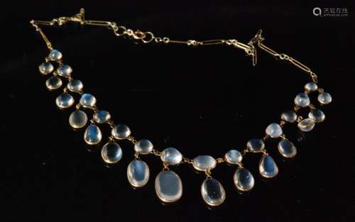 A moonstone fringe necklace designed as a series of graduated oval spectacle set stones with pendant stones below