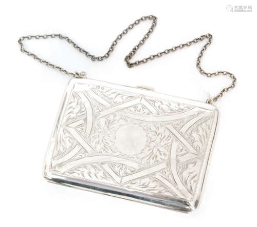 An early 20th Century hallmarked silver rectangular purse/aide memoir with foliate engraved decoration opening to brown leather compartmental interior