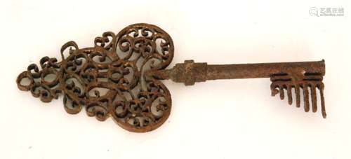 A large late 18th to early 19th Century wrought iron key with an ornate decorative filigree top