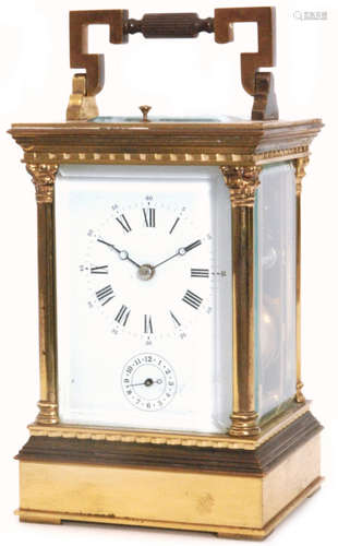 A late 19th Century French brass carriage clock in glazed pillared case with push button repeat