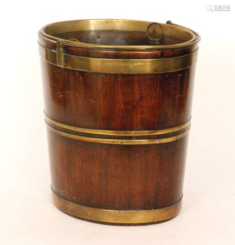 A George III mahogany and brass bound peat bucket of coopered form