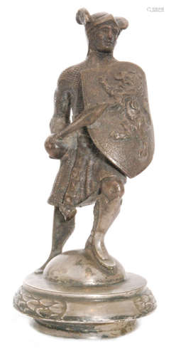 A plated car mascot in the form of a winged helmeted knight holding a spear and shield