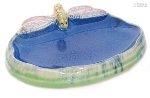 An early 20th Century Royal Doulton soap dish decorated with a mottled blue glaze to imitate water with a dragonfly perched on the side