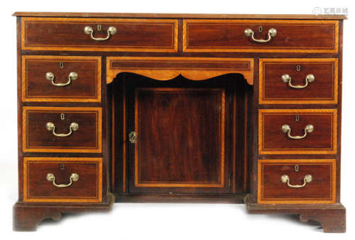 An early 20th Century satinwood banded kneehole desk in the Georgian style