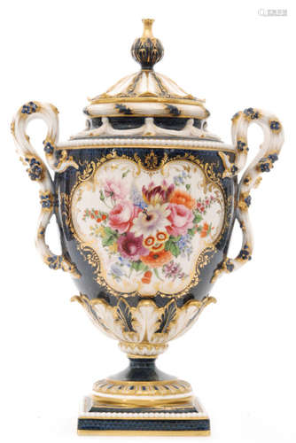 A large early 20th Century Royal Worcester shape 2340 twin handled pedestal vase and cover decorated by E Phillips with two hand painted cartouche panels with sprays of flowers and foliage within gilt frames