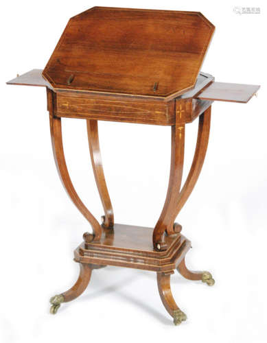 A 19th Century inlaid rosewood octagonal writing table with lift ratchet adjustable top and twin pull out candle slides on slender scroll supports and stepped platform base on conforming legs terminating in brass paw feet