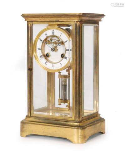 A 19th Century brass mantle clock with anchor escapement enclosed by bevelled glass sides and double filled mercury pendulum