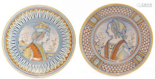 A pair of late 19th Century maiolica plates decorated with a hand painted portrait of a young gentleman in profile to one and a young lady to the other