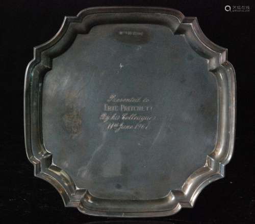 A hallmarked silver waiter of square outline with canted corners and raised pie crust border centred by an engraved dedication dated 1967