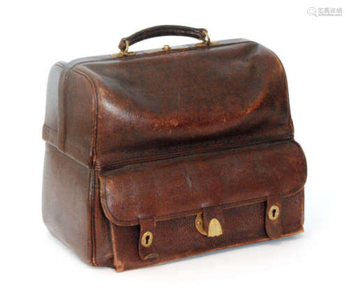 An Edwardian maroon leather Gladstone bag opening to reveal two compartments to each side