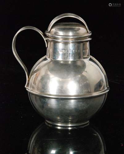 An early 20th Century hallmarked silver Jersey style jug and cover of plain form