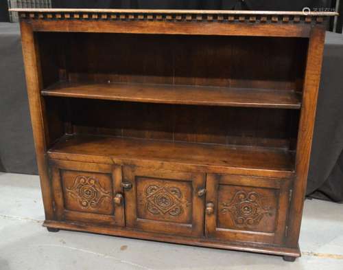 A carved oak open fronted bookcase in the 17th Century style