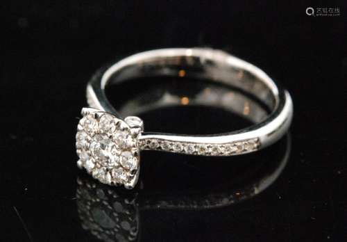 An contemporary hallmarked 18ct white gold diamond cluster ring