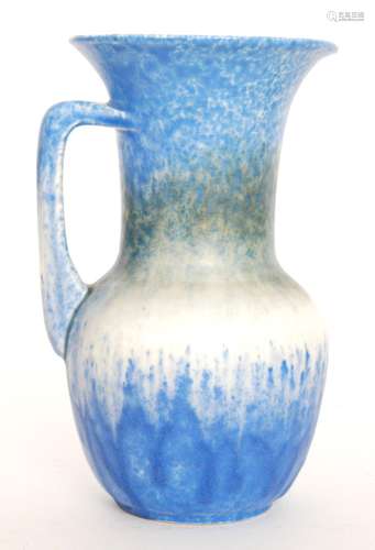 A Ruskin Pottery flower jug decorated in a blue to green to white to blue crystalline glaze