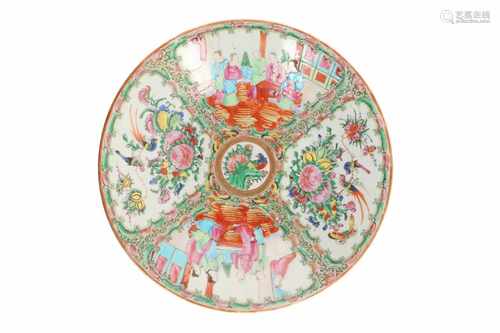 A polychrome porcelain charger, decorated with reserves in which figures, flowers and birds.