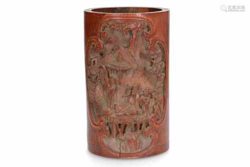 A bamboo brush pot with relief decor of figures in a mountainous landscape with buildings, and on