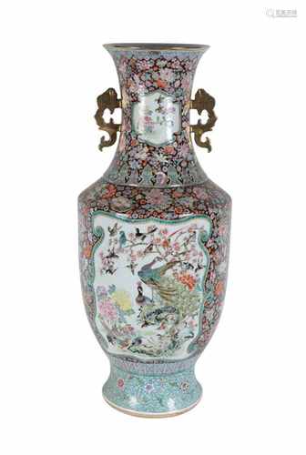 A large polychrome porcelain vase with two handles, decorated with birds in cartouches and