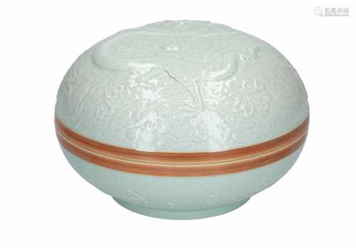 A celadon porcelain lidded bowl, decorated in relief with a dragon. Marked with seal mark