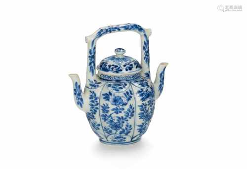 A rare blue and white porcelain lobbed jug with cover and two spouts, decorated with flowers. The