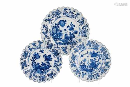 A lot of three blue and white porcelain dishes with scalloped rim, decorated with flowers and birds.